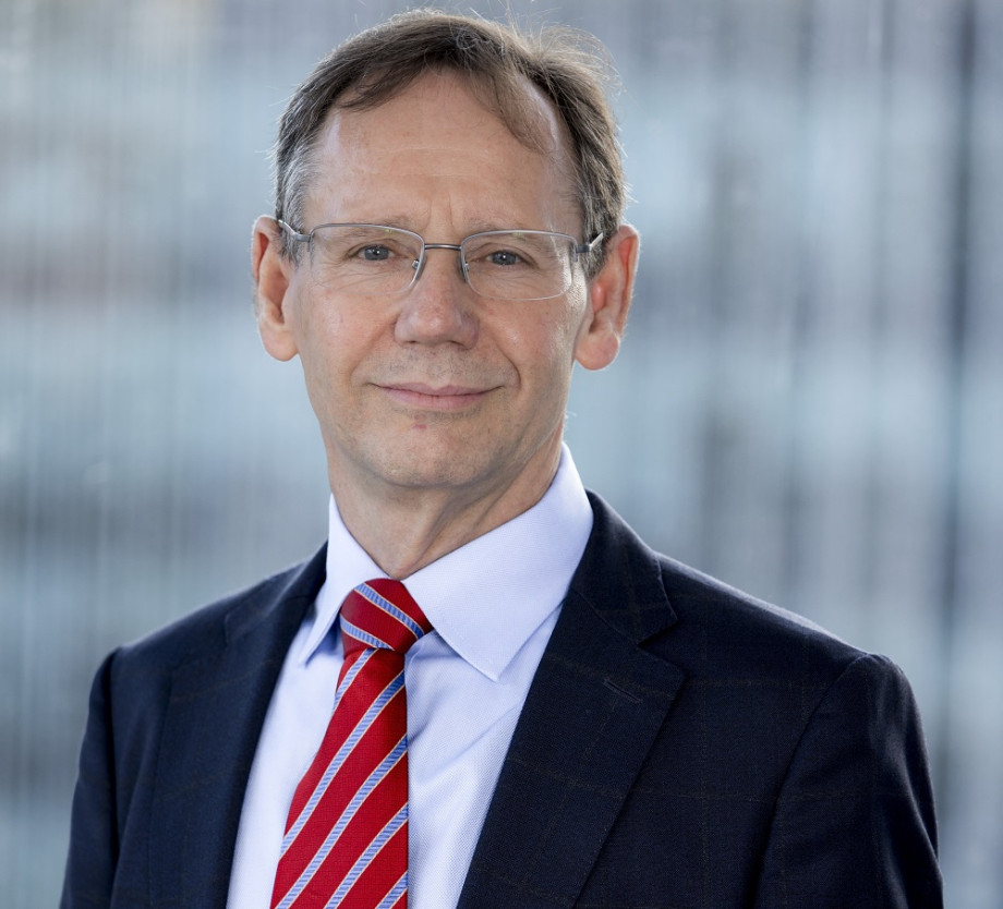 Smiling man with glasses and tie